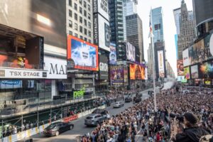 A picture of Times Square shows it packed with fans as Malone sings from above on the TSX stage.