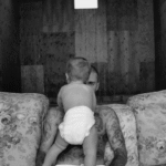 Black and white photo of Justin Bieber holding his baby.